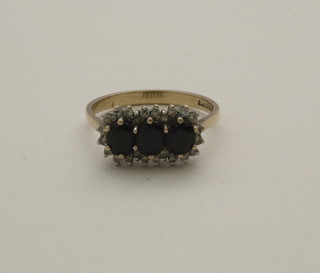 A 9ct gold cluster dress ring set oval cut sapphires and diamonds