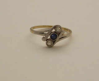 An 18ct gold dress ring set a sapphire supported by 2 diamonds