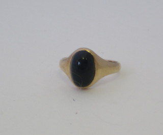 A gold signet ring set a cabouchon cut green stone