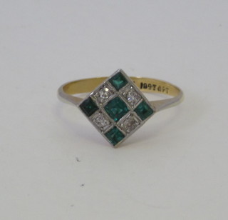 An 18ct gold dress ring set diamonds and emeralds