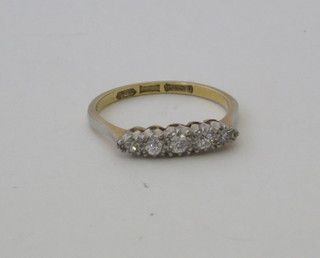 An 18ct yellow gold dress ring set 5 illusion cut diamonds