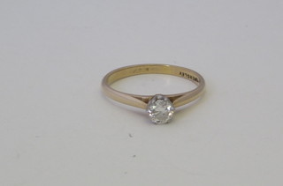 A 14ct yellow gold dress ring set a solitaire diamond