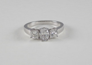 A lady's 18ct white gold dress/engagement ring set an oval  Princess cut diamond supported by 2 diamonds, approx 1.75ct