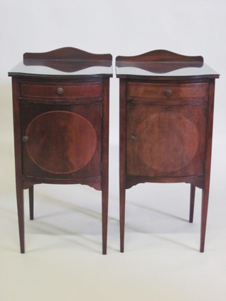 A pair of Edwardian Georgian style mahogany bow front bedside cabinets, raised on square tapering supports