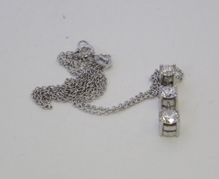 An 18ct white gold pendant set 3 diamonds, approx 0.75ct, hung  on a fine gold chain