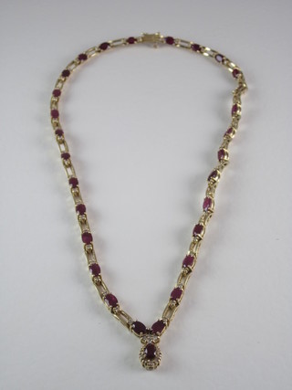 A  yellow metal necklace set rubies and diamonds