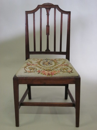 A Georgian mahogany stick and rail back dining chair with upholstered drop in seat, raised on turned supports with H framed  stretcher