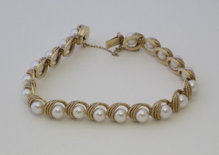 A 14ct gold bracelet set demi-pearls