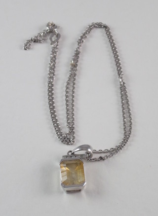 An 18ct white gold fine chain hung a platinum pendant set white stones and a rectangular brown stone