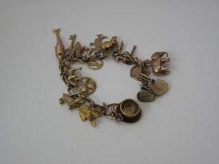A gold charm bracelet hung numerous charms