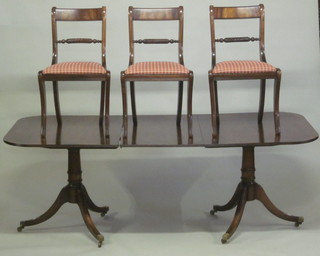 A Georgian style dining suite comprising twin pillar D end  extending dining table with 1 extra leaf and 8 bar back dining  chairs with rope stretchers