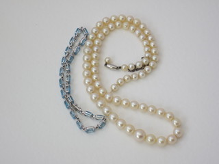 A lady's white gold bracelet set oval "aquamarines" together with a rope of cultured pearls with platinum clasp