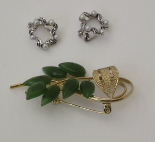 A floral gilt metal brooch set a green hardstone and a pair of ear  clips