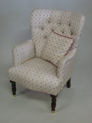 A Victorian style mahogany tub back chair upholstered in floral buttoned material