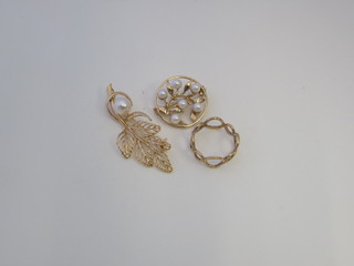 An 18ct gold brooch set a pearl, a 9ct gold brooch set pearls and  a gilt metal ring