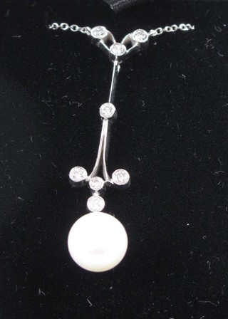 A pearl and diamond pendant hung on a fine 18ct white gold  chain