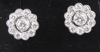 A pair of diamond cluster earrings, approx 1.25ct