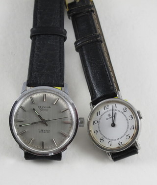 A gentleman's Delvina wristwatch contained in a stainless steel  case and a lady's Cyma wristwatch in a stainless steel case