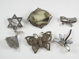 An oval mother of pearl finished brooch, a marcasite brooch in  the form of a butterfly, do. dancing lady, ribbon garland, Star of  David and an insect brooch