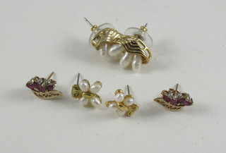 A pair of gold earrings and 2 other pairs of earrings