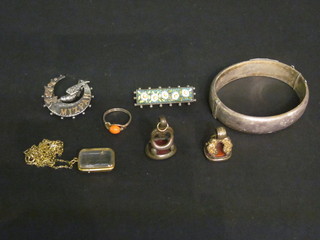 An engraved silver bracelet, 2 seals, a micro mosaic brooch, a gilt metal ring, a crystal locket hung on a gilt chain and a silver  and gold mizpah brooch