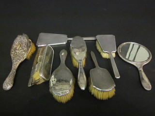 2 silver backed hand mirrors and 5 silver backed hair brushes, a silver backed clothes brush and a silver cased comb