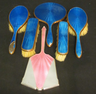 A silver plated and pink enamelled hand mirror together with a 5  piece blue enamelled dressing table set
