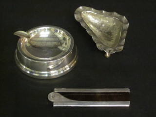 A circular silver ashtray 3 1/2", an oyster shaped dish and a comb