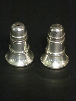 A silver salt and pepper of waisted cylindrical form, Birmingham  1931