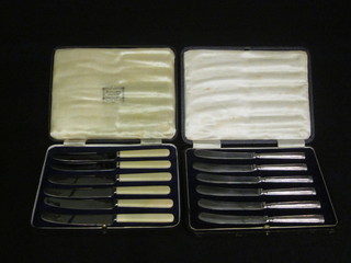 A set of 6 tea knives with silver handles, cased together with a set of silver tea knives with bone handles, cased