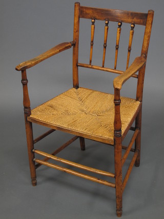 An 18th/19th Century elm stick back carver chair with woven  rush seat