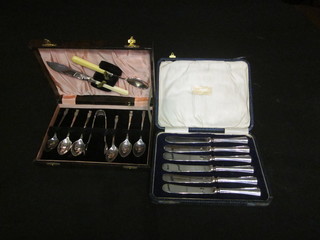 A set of 6 silver plated teaspoons with thistle decoration and  tongs and a set of 6 silver handled tea knives