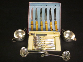 A set of 6 bamboo handled steak knives, 6 silver plated grapefruit spoons, a pair of sauce ladles and a twin handled sugar bowl and  cream jug