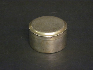 A cylindrical white metal jar and cover
