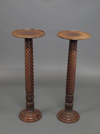 A pair of 19th Century turned mahogany bed post torcheres
