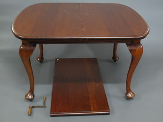 A mahogany extending dining table raised on cabriole supports