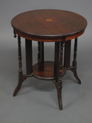 A circular Victorian rosewood 2 tier occasional table raised on  outswept supports 24"