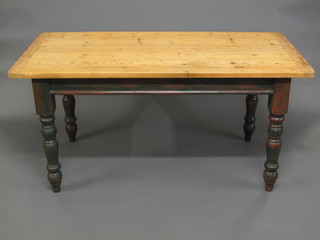 A rectangular pine table with green painted base, raised on turned supports 62"