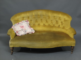 A 19th Century French mahogany framed sofa upholstered in  yellow material, raised on turned supports 54"