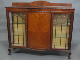 An Edwardian Chippendale style mahogany bow front display  cabinet fitted a cupboard enclosed by a bow front panelled door, flanked by a pair of cupboards fitted adjustable shelves enclosed  by astragal glazed doors, raised on cabriole ball and claw  supports 60"