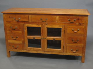 A teak sideboard fitted 3 long drawers above a double cupboard enclosed by glazed panelled doors, flanked by 4 short drawers  61"