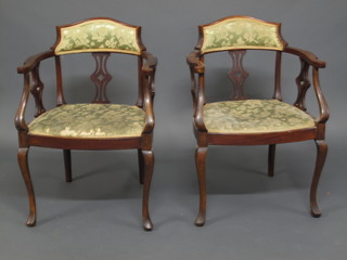 A pair of Edwardian mahogany tub back open arm armchairs  raised on cabriole supports
