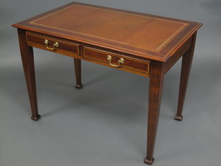 An Edwardian inlaid mahogany writing table with inset tooled leather writing surface, fitted a drawer and raised on square  tapering supports 42"