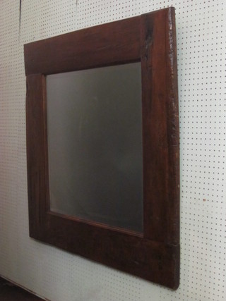 A square bevelled plate wall mirror contained in a heavy oak  frame 41"