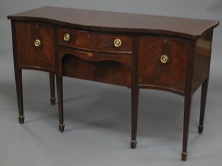 A Georgian style mahogany sideboard of serpentine outline, fitted  2 drawers flanked by a pair of cupboards, raised on square  tapering supports ending in spade feet 60"