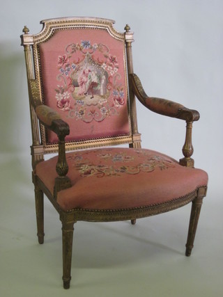 A 19th Century gilt painted open arm salon chair, the seat and back upholstered in pink Berlin woolwork panels, raised on  turned and fluted supports