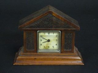 An Art Deco American timepiece with paper dial and Arabic numerals by Ansonia, contained in an oak case