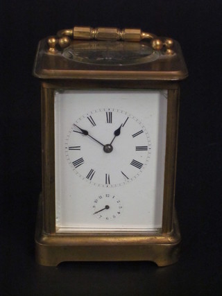A 19th Century French 8 day carriage alarm clock with  enamelled dial contained in a gilt case ILLUSTRATED