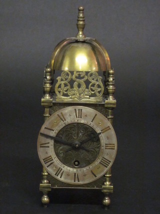 A Smiths lantern clock with silvered chapter ring and Roman numerals, contained in a gilt metal case 4"