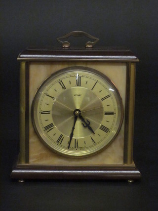 A battery operated mantel clock with gilt chapter ring and Roman numerals by Metac